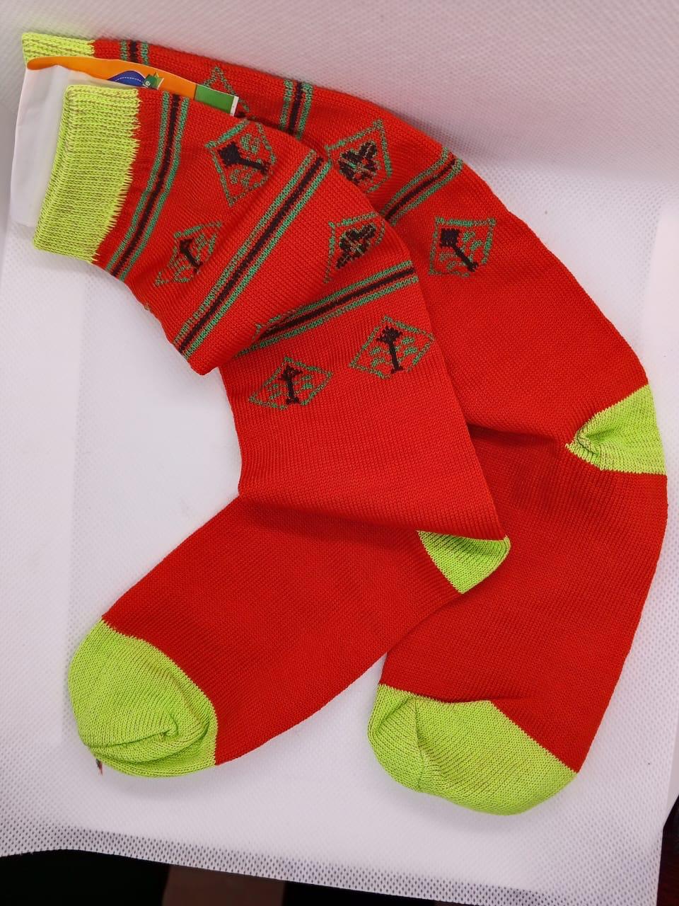 Red low-cut socks with neon green heel and toe and patterned design from Trainers Feet on a white background.
